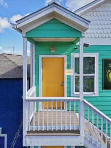 a blue and green house with a yellow door at Ninas Villas - Brand New Luxury Villas in Galveston