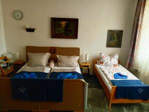 a bedroom with two beds and a clock on the wall at Gasthaus & Pension Schmidt's in Haldensleben +14 photos