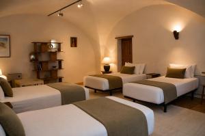 a room with three beds in a room at Le Mas de la Vivande in Marsanne +17 photos