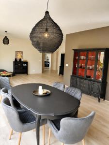 a dining room with a black table and chairs at Elliðaár Valley Guesthouse in Reykjavík