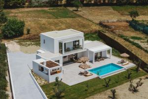 an aerial view of a white house with a swimming pool at Serenita luxury villa in Zakynthos