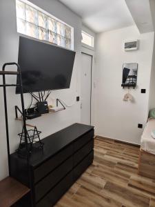 a living room with a large flat screen tv on a wall at Studio 714 in Škaljari