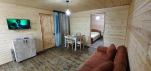 a living room with a couch and a bedroom at Midamo in Manglisi