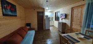 a living room with a couch and a kitchen at Midamo in Manglisi