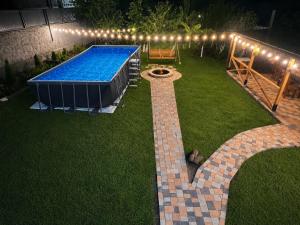 a backyard with a swimming pool and a table and lights at Ohanavan Garden Guesthouse in Oganavan
