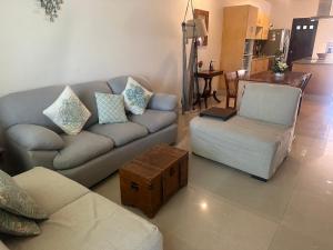 a living room with a couch and a chair at Condo Riviera in Puerto Aventuras +11 photos