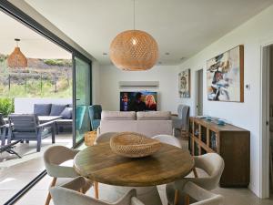 a living room with a table and chairs at Higuerón Prestige homes in Fuengirola