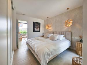 a bedroom with a large white bed with two pillows at Higuerón Prestige homes in Fuengirola +46 photos