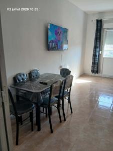 a dining room table and chairs in a room at سكيكدة الجزائر in Skikda