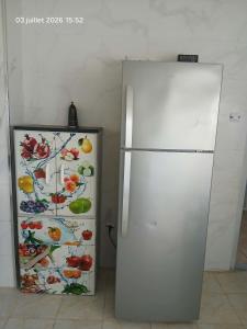 a white refrigerator next to another refrigerator with fruits and vegetables on it at سكيكدة الجزائر in Skikda