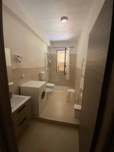 a bathroom with a sink and a washing machine at Trinacria in Montevago