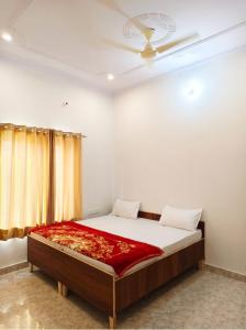 a bedroom with a large bed with a ceiling at Barsana Geust House in Khātu