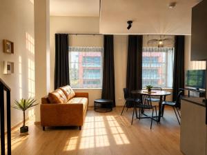 a living room with a couch and a table at Filosoofi Suites in Tartu