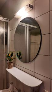 a bathroom with a mirror and a sink at EVIA Hotel restaurant in Recklinghausen +45 photos