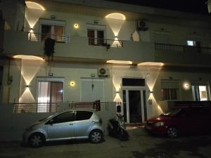 two cars parked in front of a building at night at The Eliana Serenade in Heraklio
