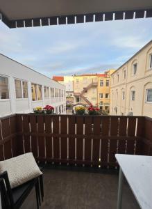 a balcony with a wooden fence and some buildings at Midtown Apartment Hannover in Hannover