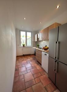 a kitchen with a tile floor and a refrigerator at Midtown Apartment Hannover in Hannover