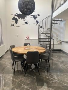 a table and chairs in a room with a world on the wall at Olivia Suite in Pano Arodes