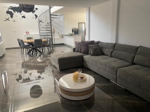 a living room with a couch and a table at Olivia Suite in Pano Arodes