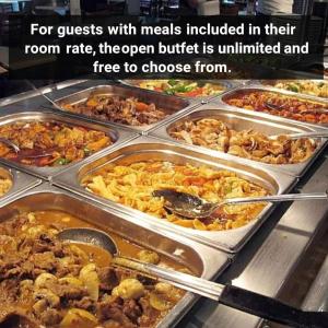 a buffet filled with many trays of food at Qorqud Hotel - Free Massage in Baku