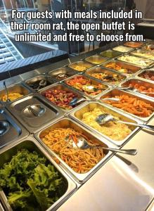 a buffet filled with many trays of food at Qorqud Hotel - Free Massage in Baku +67 photos