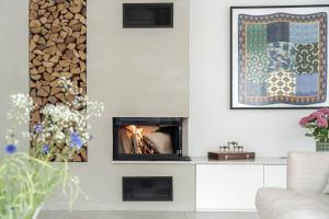 a living room with a fire place in the wall at Seaside villa with pool in Simrishamn