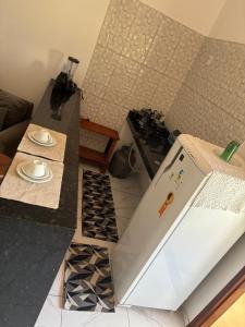 a kitchen with a counter top with a stove at Pousada Apart Praia Uruaú in Beberibe