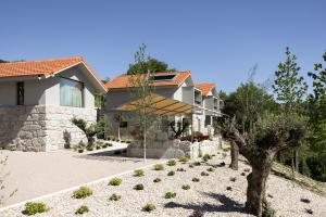 a house with a landscaping in front of it at Passinhos House in Amarante