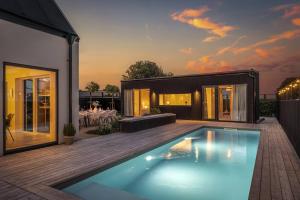 a swimming pool in the backyard of a house at Seaside villa with pool in Simrishamn