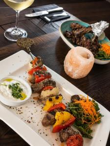 a plate of food with meat and vegetables on a table at EVIA Hotel restaurant in Recklinghausen
