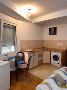 a small kitchen with a bed and a table at M apartment in Ohrid