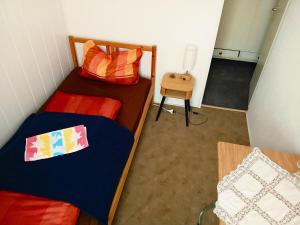 a small room with two beds and a table at Gasthaus & Pension Schmidt's in Haldensleben