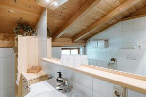 a bathroom with a sink and a mirror at Appartement Seppenbauer - Seppenbauerhof, Kärnten Card inklusive, Ticket Großglockner Hochalpenstraße in Heiligenblut +69 photos