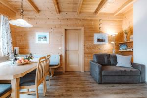 a living room with a table and a couch at Appartement Seppenbauer - Seppenbauerhof, Kärnten Card inklusive, Ticket Großglockner Hochalpenstraße in Heiligenblut