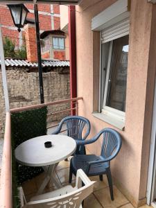 two chairs and a table on a balcony at M apartment in Ohrid