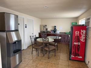 a kitchen with a table and a coke machine at Sunshine Motel in Yakima