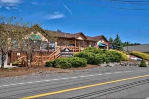 a log home with a sign in front of it at Lake Luxe in Lake Ariel