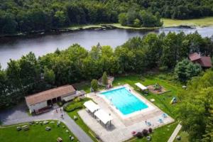 an overhead view of a large swimming pool next to a lake at Lake Luxe in Lake Ariel