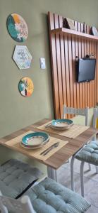 a wooden table with plates on top of it at Cantinho do Sol e Mar in São Vicente