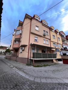 a large building on the side of a street at M apartment in Ohrid