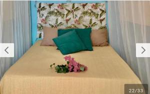 a bed with a bunch of flowers on it at Vistamar Arco das Flores 2 in Taíba