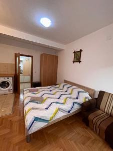 a bedroom with a bed and a couch at M apartment in Ohrid