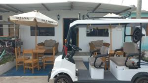 a golf cart parked in front of a restaurant at casa posada cabaña paracas in Paracas