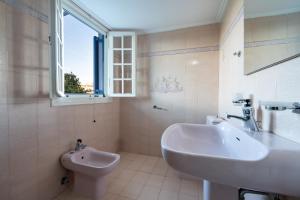 a bathroom with a sink and a toilet at Lemon Garden Apartments in Lygia +39 photos