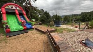 a playground with a slide in a park at Domek letniskowy Jemiołowo in Olsztynek +12 photos