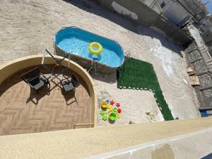 an overhead view of a swimming pool in a backyard at Spacious Villa-walking to beach in Marsa Matruh