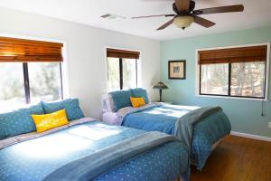 a bedroom with two beds and a ceiling fan at Pine Hills Cabin in Julian in Julian