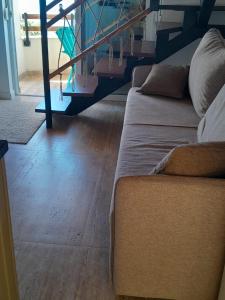 a living room with two couches and a wooden floor at Apartman 4 sa spavacom in Zelenika
