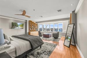 a bedroom with a bed and a living room at 5 bdrm - Heated Indoor Pool - Roof Top Deck in Philadelphia +125 photos