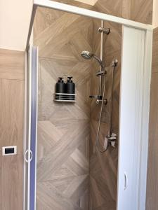 a bathroom with a shower with two pots at Cà di Grè - Camigliatello Silano in Camigliatello Silano +47 photos